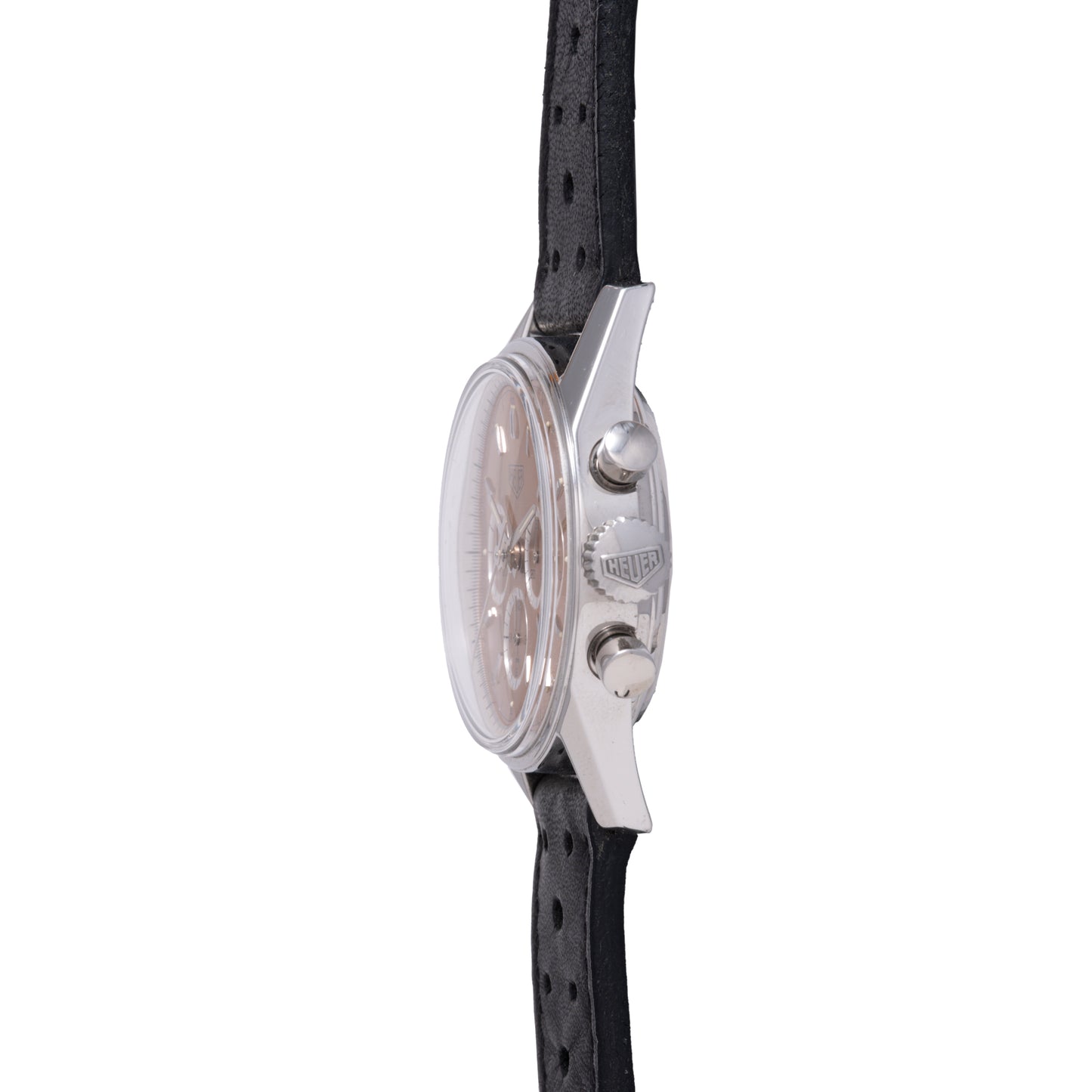Side view of the TAG Heuer 1964 Carrera Re-Edition, a silver round chronograph with two pushers, crown showing the TAG Heuer logo, and a perforated black leather strap—classic vintage-inspired style.