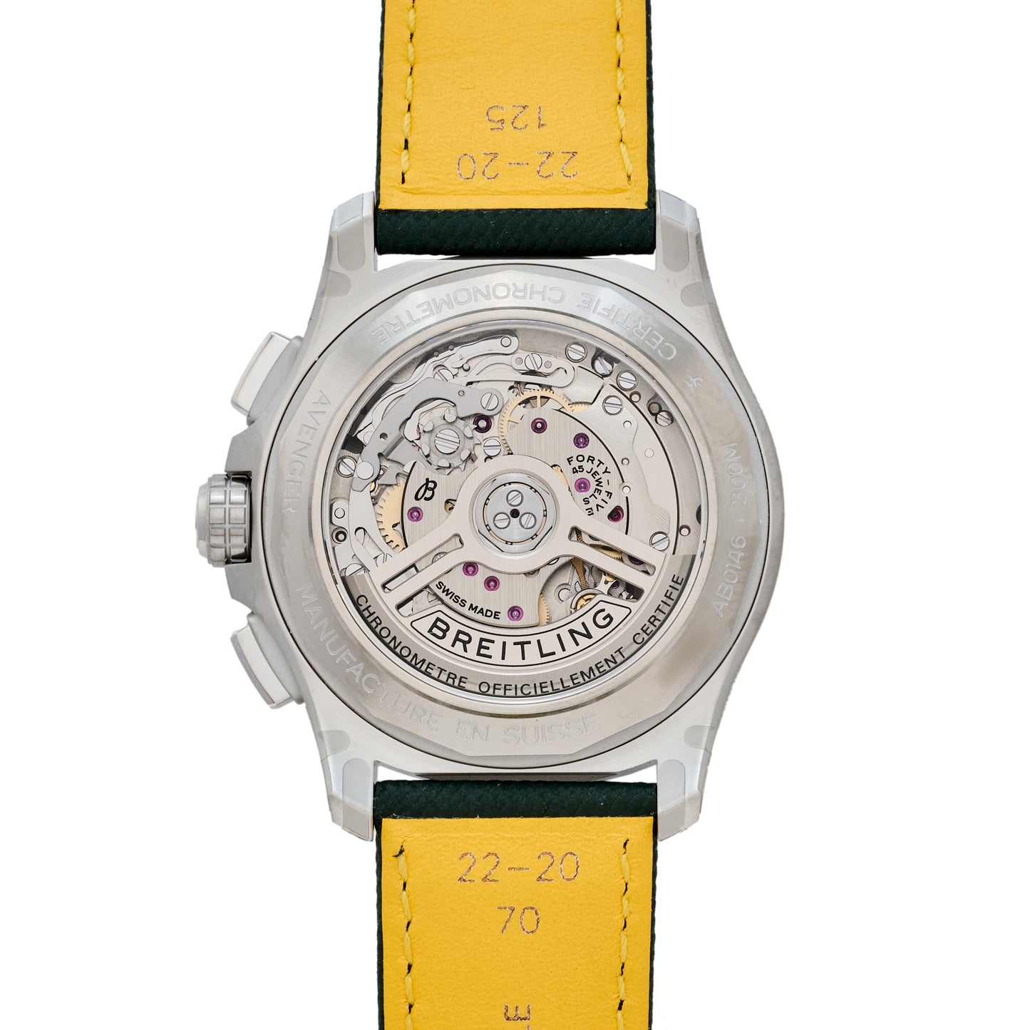 Close-up of the Breitling Avenger B01 Chronograph 42’s back, displaying its detailed mechanical chronograph movement through a transparent caseback and yellow leather strap engraved with numbers.
