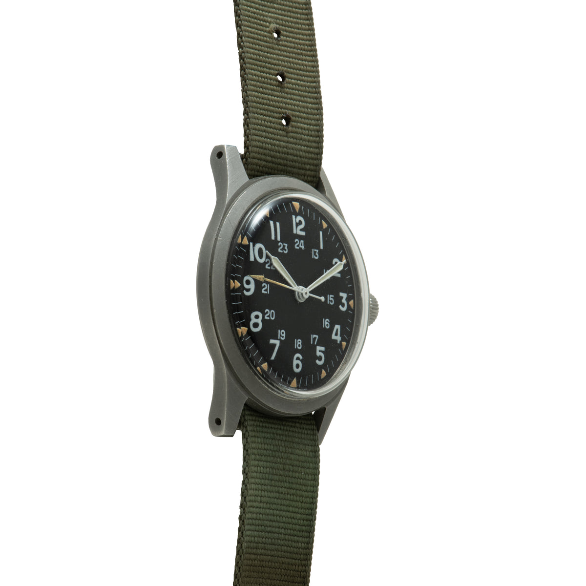 Hamilton GG-W-113 watch with black dial, Arabic numerals, steel case, and olive green fabric strap.