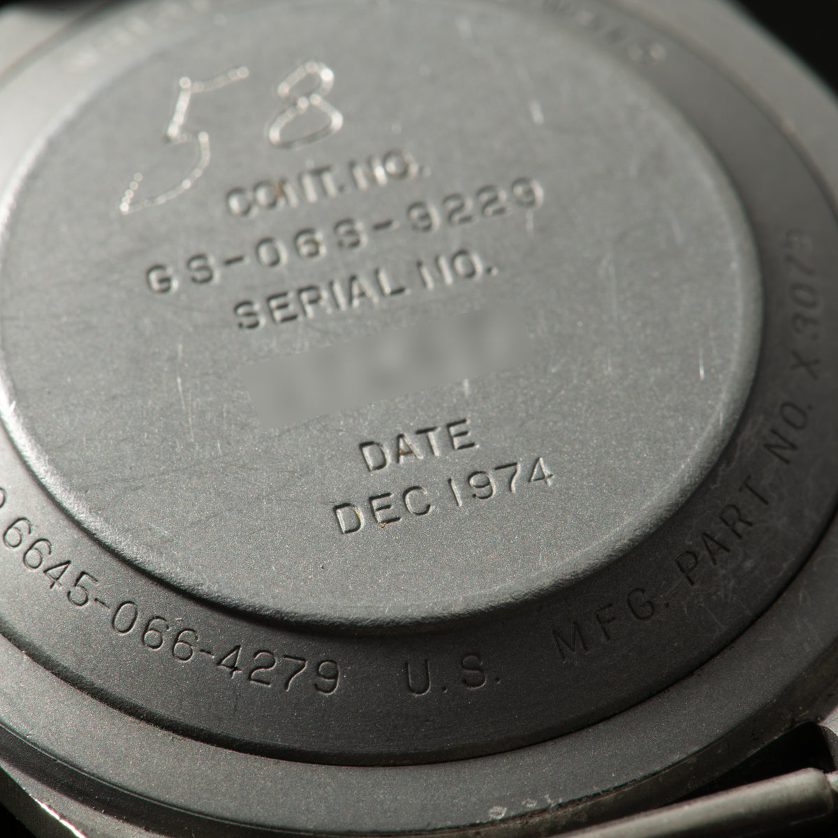 Close-up of watch case back showing model number GS-0663-3229, serial number, and December 1974 date.