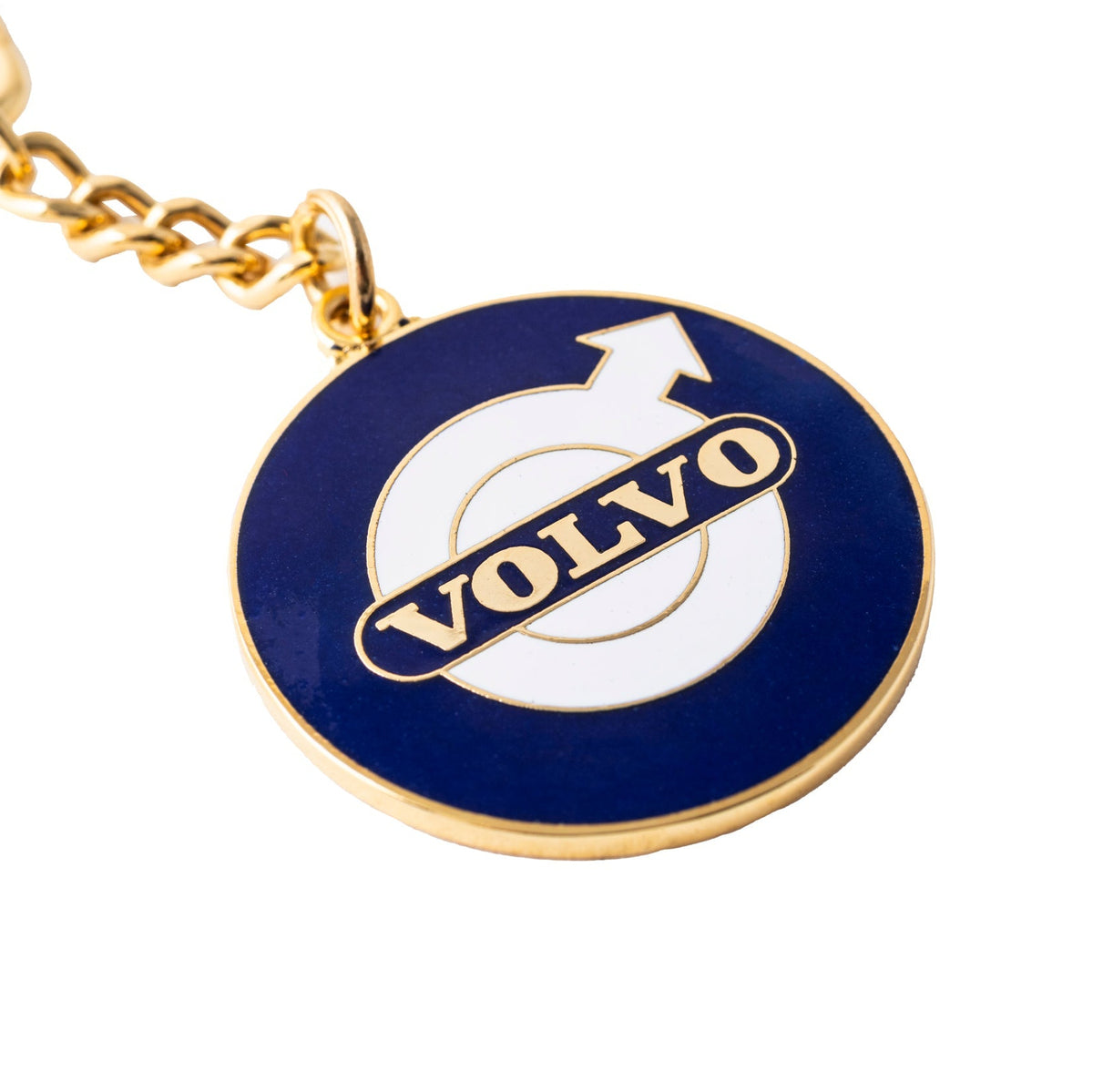 Gold-toned key chain with round blue and white enamel pendant featuring Volvo logo and arrow.