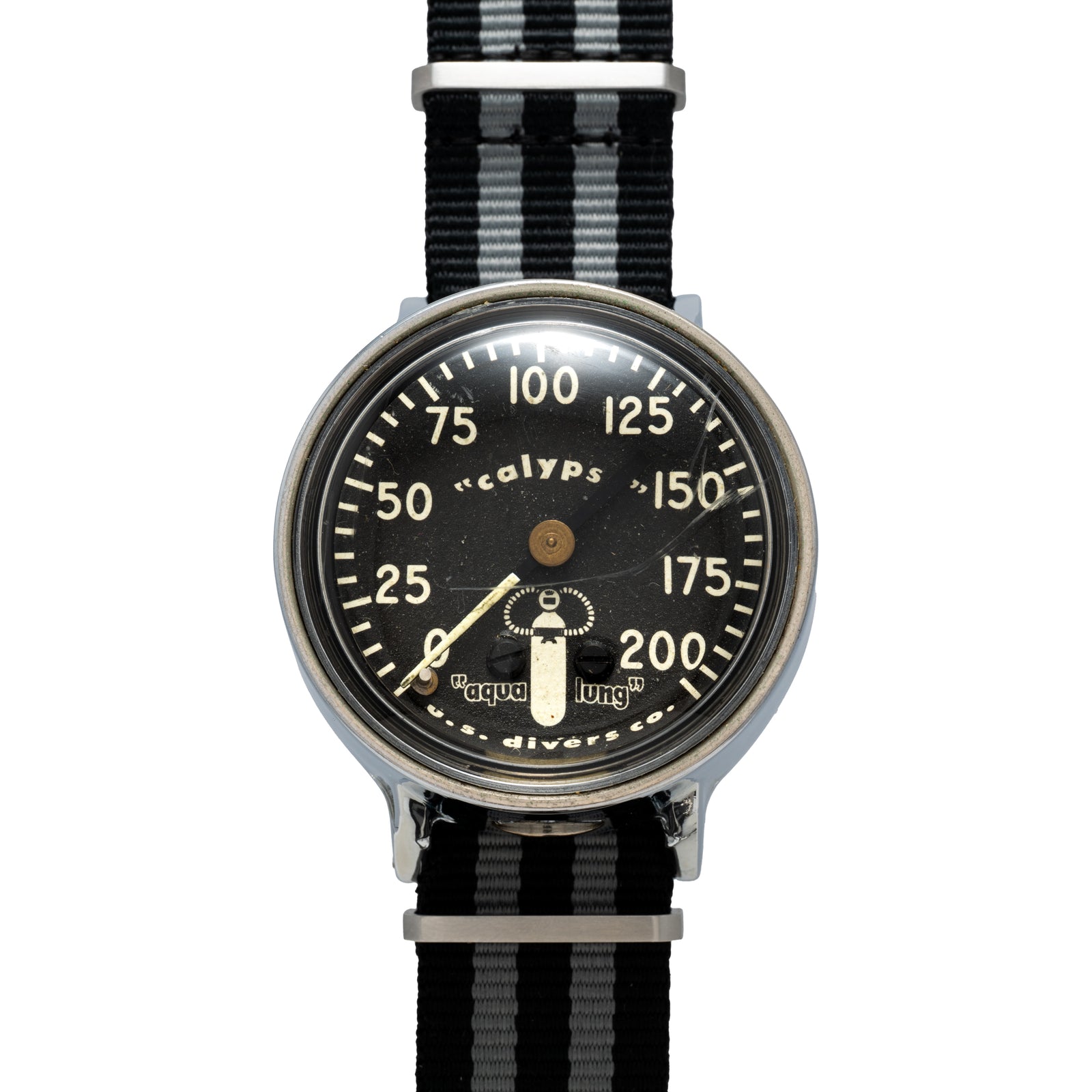 The Calypso Depth Gauge by Calypso is a vintage divers watch with a mechanical depth gauge on its black dial, white numbers, 0–200 display, single central hand, and a black-and-grey striped fabric strap—ideal for scuba diving.