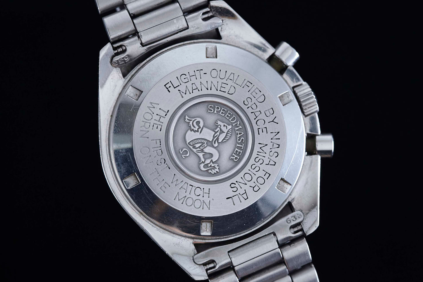 Close-up of the Omega Speedmaster Professional’s caseback, engraved with “Flight-qualified by NASA for all manned space missions” and “The first watch worn on the moon” by Omega.
