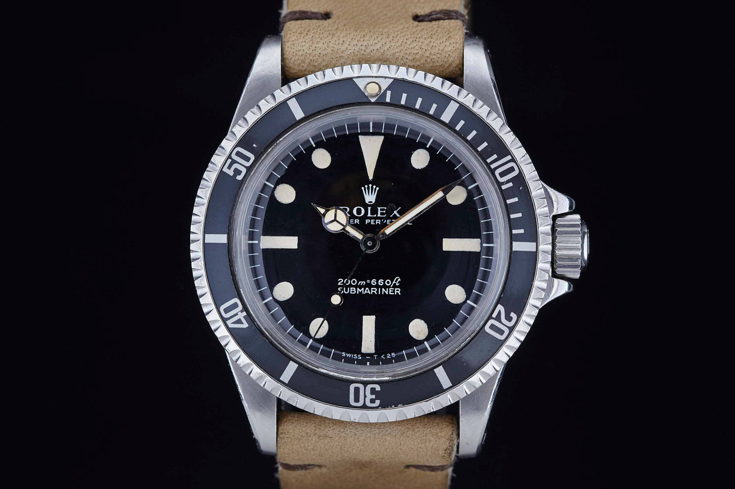 A close-up of a Rolex Submariner wristwatch by Rolex, featuring a black dial, white hour markers, and a beige leather strap, set against a black background. The watch displays the time 8:22:34.