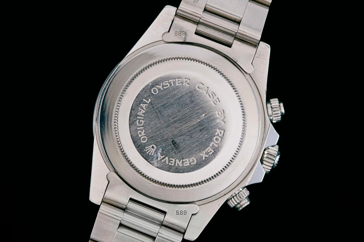 The back of the Tudor Monte Carlo 9420/0, with engraved text "ORIGINAL OYSTER CASE BY ROLEX GENEVA" around the edge, highlights Tudor quality—a nod to its shared heritage with Rolex—paired with a stainless steel bracelet.