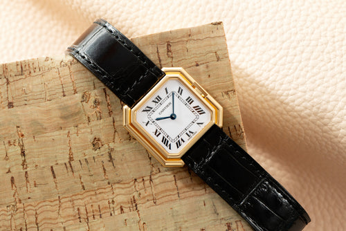 27 mm yellow-gold Ceinture with its Paris-signed white Roman dial, on a black strap. · Photo: Analog:Shift · © Analog:Shift, used with permission · Source: https://www.analogshift.com/products/cartier-ceinture-as09196