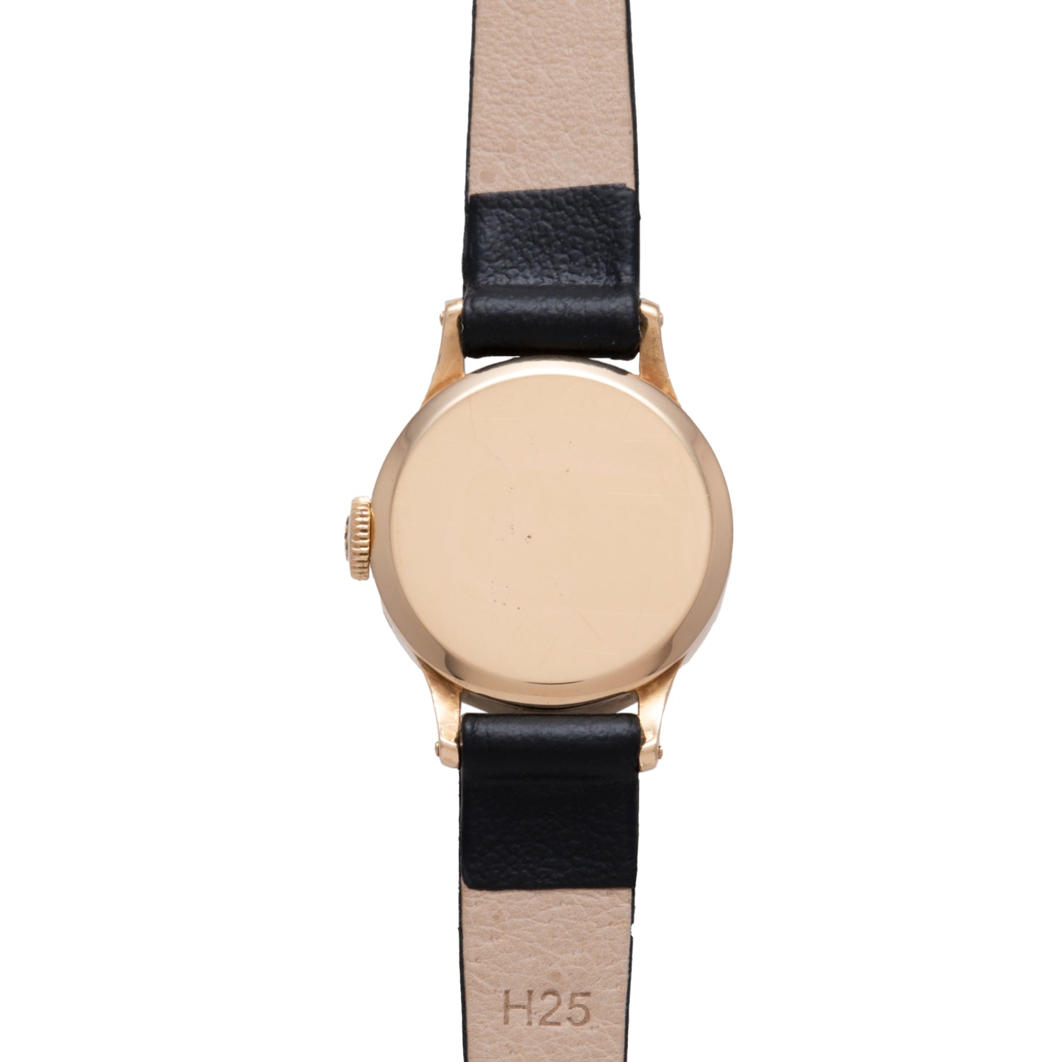 The Patek Philippe Calatrava 'Tiffany & Co' ladies dress watch features a gold case and black and beige leather strap, shown from the back with "H25" stamped inside, embodying timeless elegance.