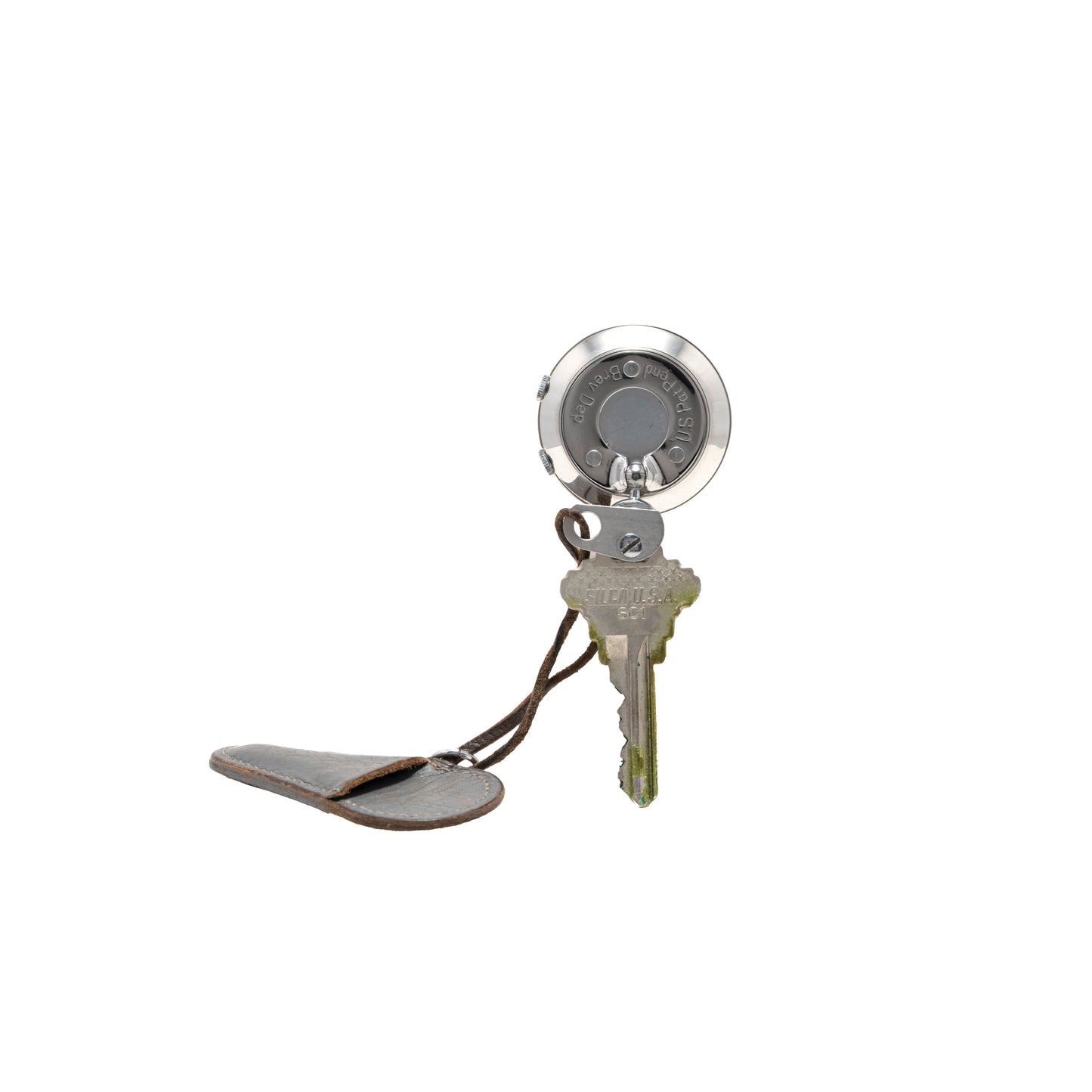 The Saint Blaise Key Watch Alarm by Saint Blaise features a single metal key on a retractable keychain with a round clip and leather cover, making it an ideal accessory for classic car enthusiasts, displayed on a white background.