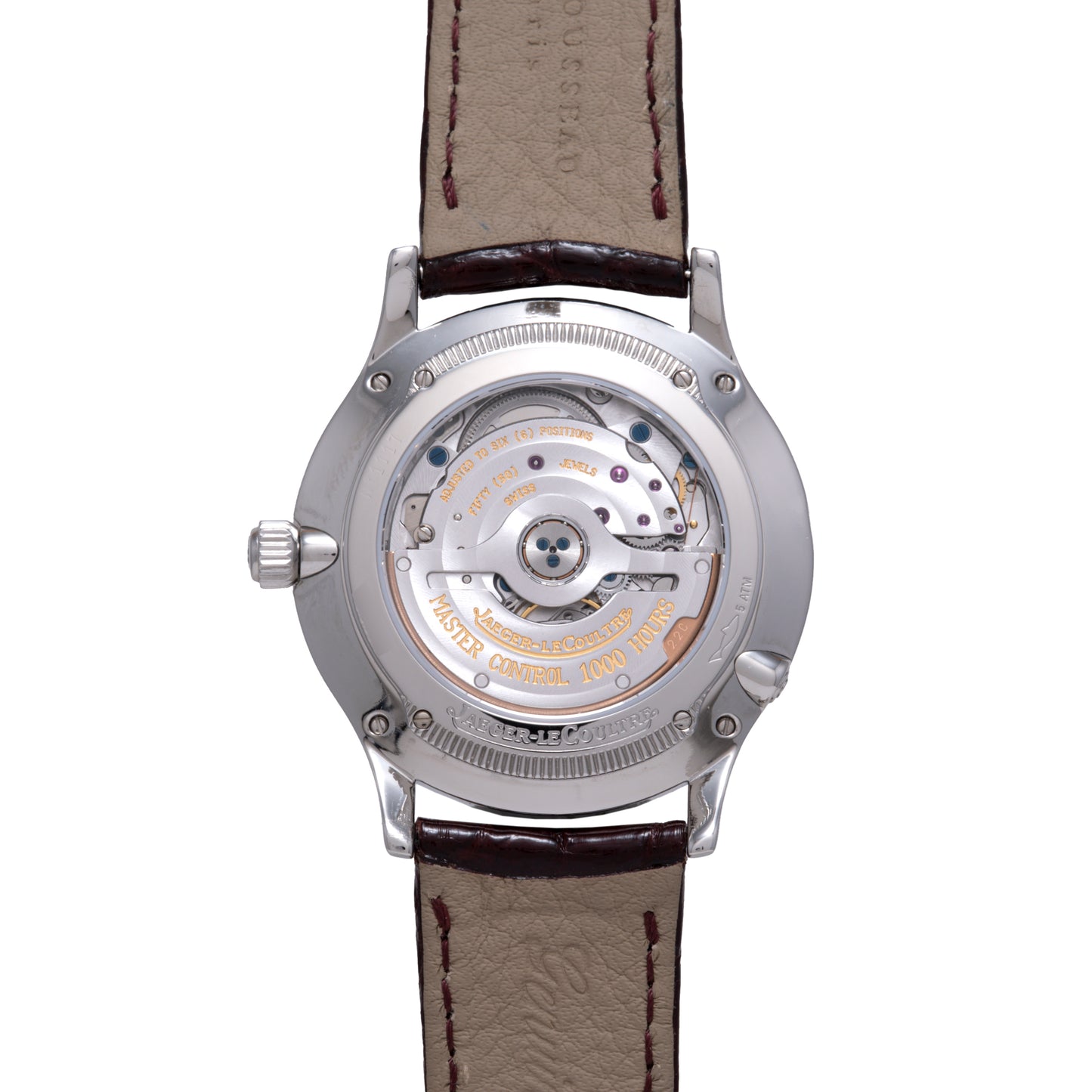 The Jaeger LeCoultre Master Control Perpetual Calendar’s caseback displays its detailed mechanical movement and engraved text, while the brown leather strap with visible stitching lends a classic vintage style.