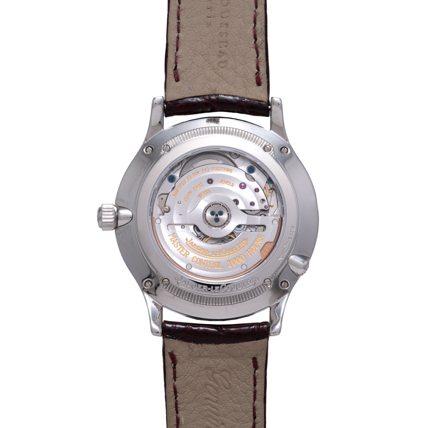 The Jaeger LeCoultre Master Control Perpetual Calendar’s caseback displays its detailed mechanical movement and engraved text, while the brown leather strap with visible stitching lends a classic vintage style.