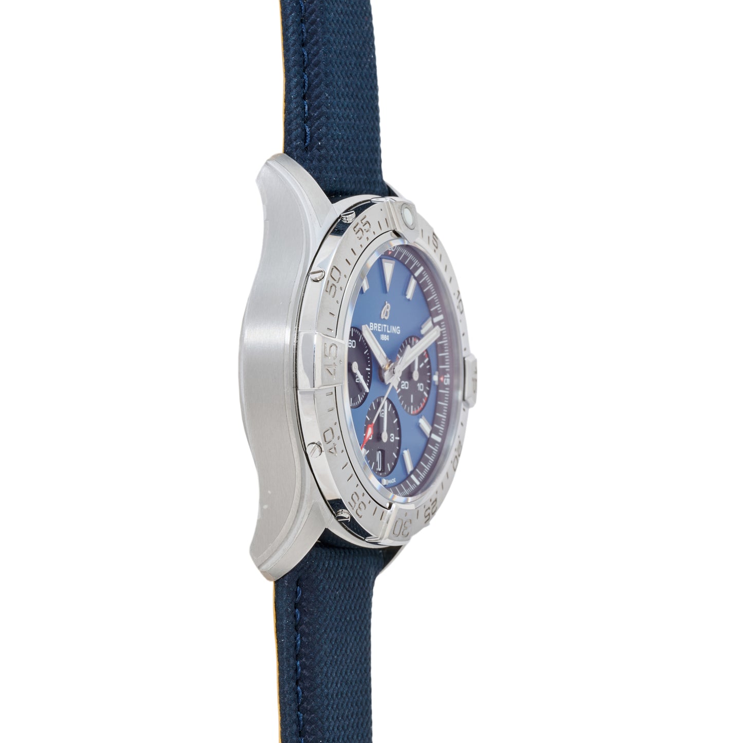 Side view of the Breitling Avenger B01 Chronograph 42 aviation watch in silver, with a blue dial, three chronograph subdials, white hour markers, blue fabric strap, and a numbered engraved bezel on a brushed case for sporty elegance.