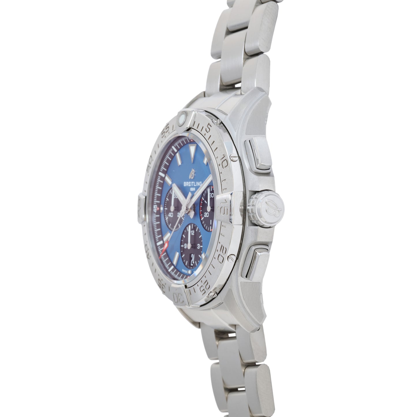 The Breitling Avenger B01 Chronograph 42, in silver with a blue dial, three subdials, and a stainless steel linked bracelet, is shown from an angled side view. This aviation watch features a COSC-certified automatic movement.