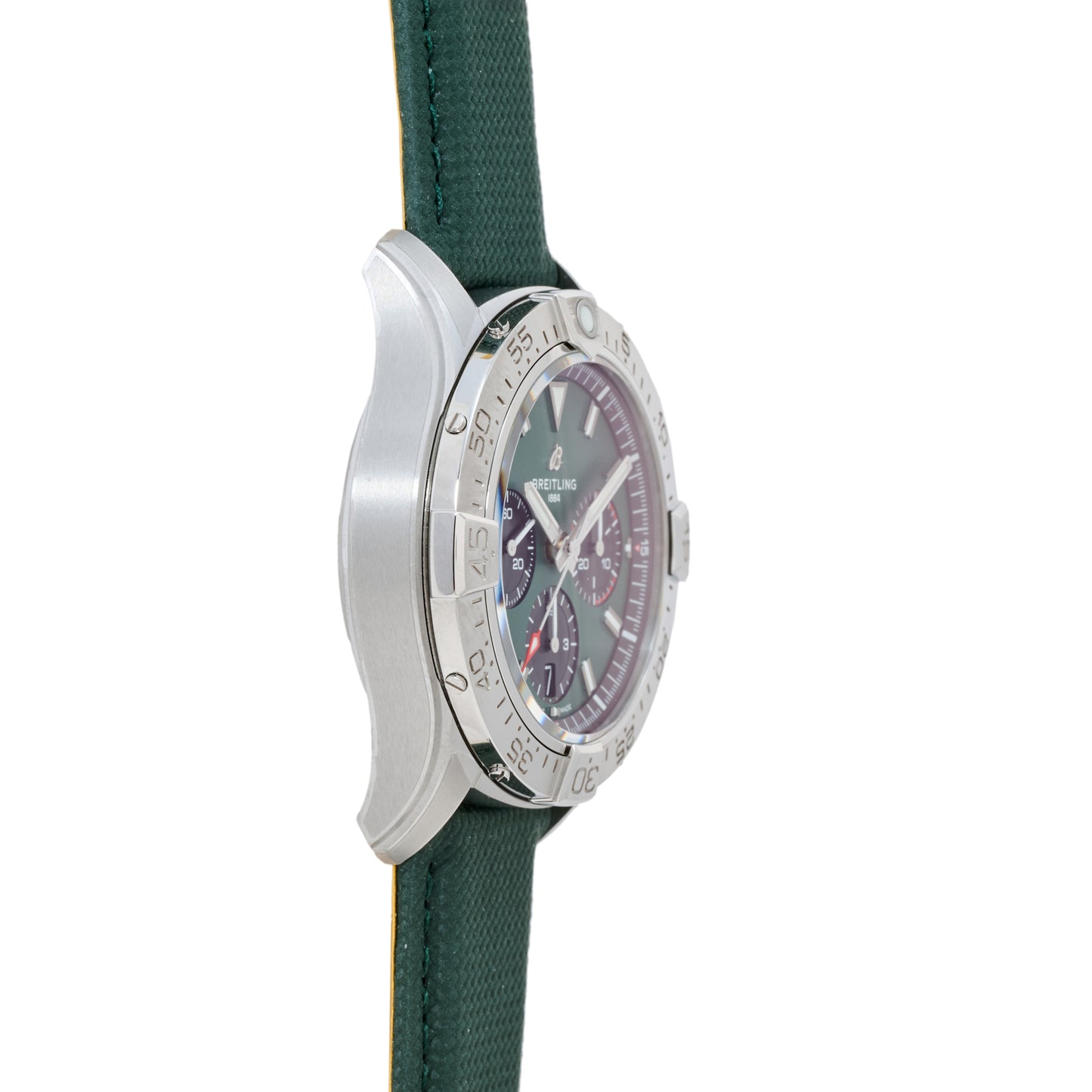 A side view of the Breitling Avenger B01 Chronograph 42 shows its silver bezel, dark dial, and green fabric strap, emphasizing the chronograph’s thickness and partial face details.