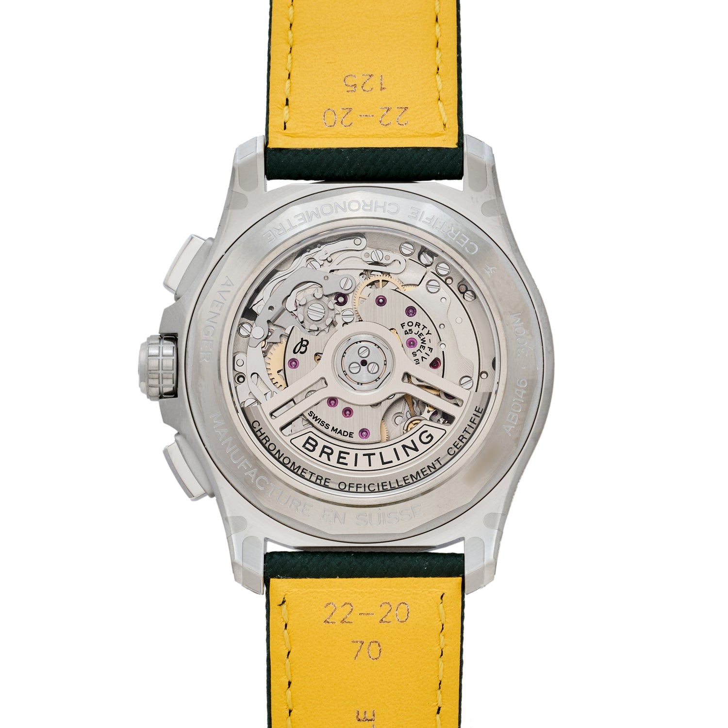 Close-up of the Breitling Avenger B01 Chronograph 42’s back, displaying its detailed mechanical chronograph movement through a transparent caseback and yellow leather strap engraved with numbers.