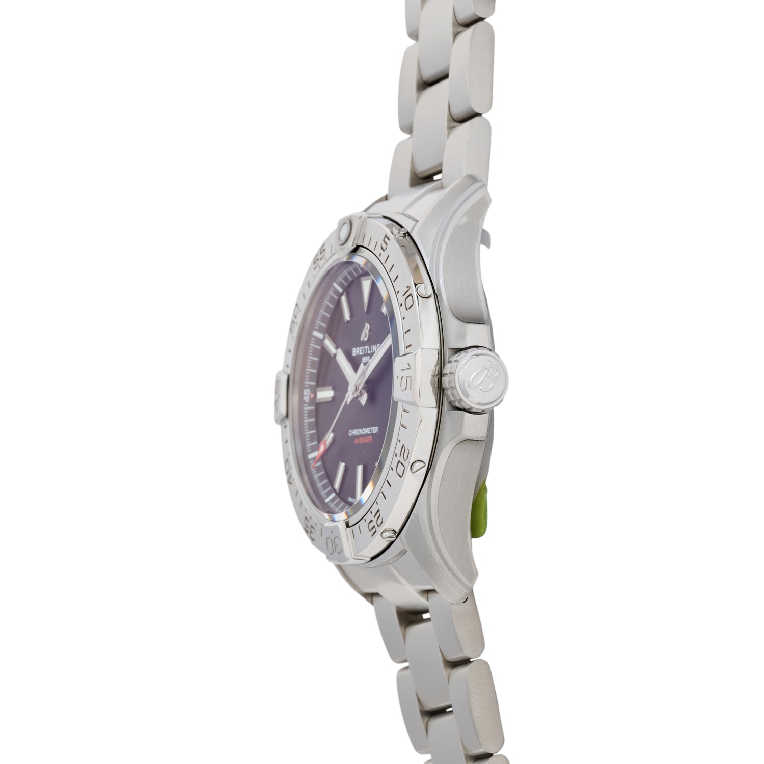 Side view of the Breitling Avenger Automatic 42, a silver aviation watch with a metal link band, round bezel with engraved markings, dark dial, white hour markers and hands, and a crown featuring the Breitling logo.
