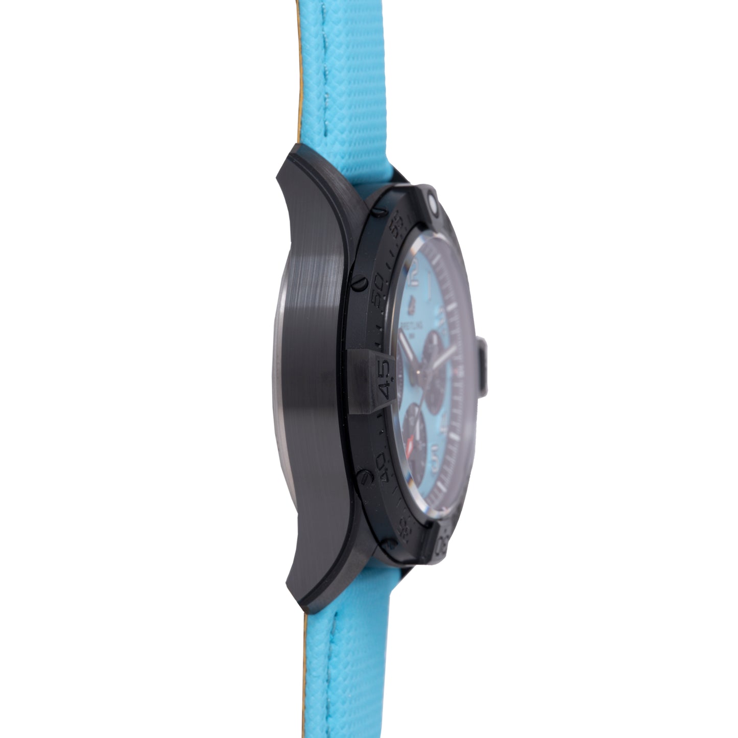 A close-up side view of a black ceramic Breitling Super Avenger B01 Chronograph 42 with a light blue strap highlights its textured, polished detailing and hints at the bold face design.