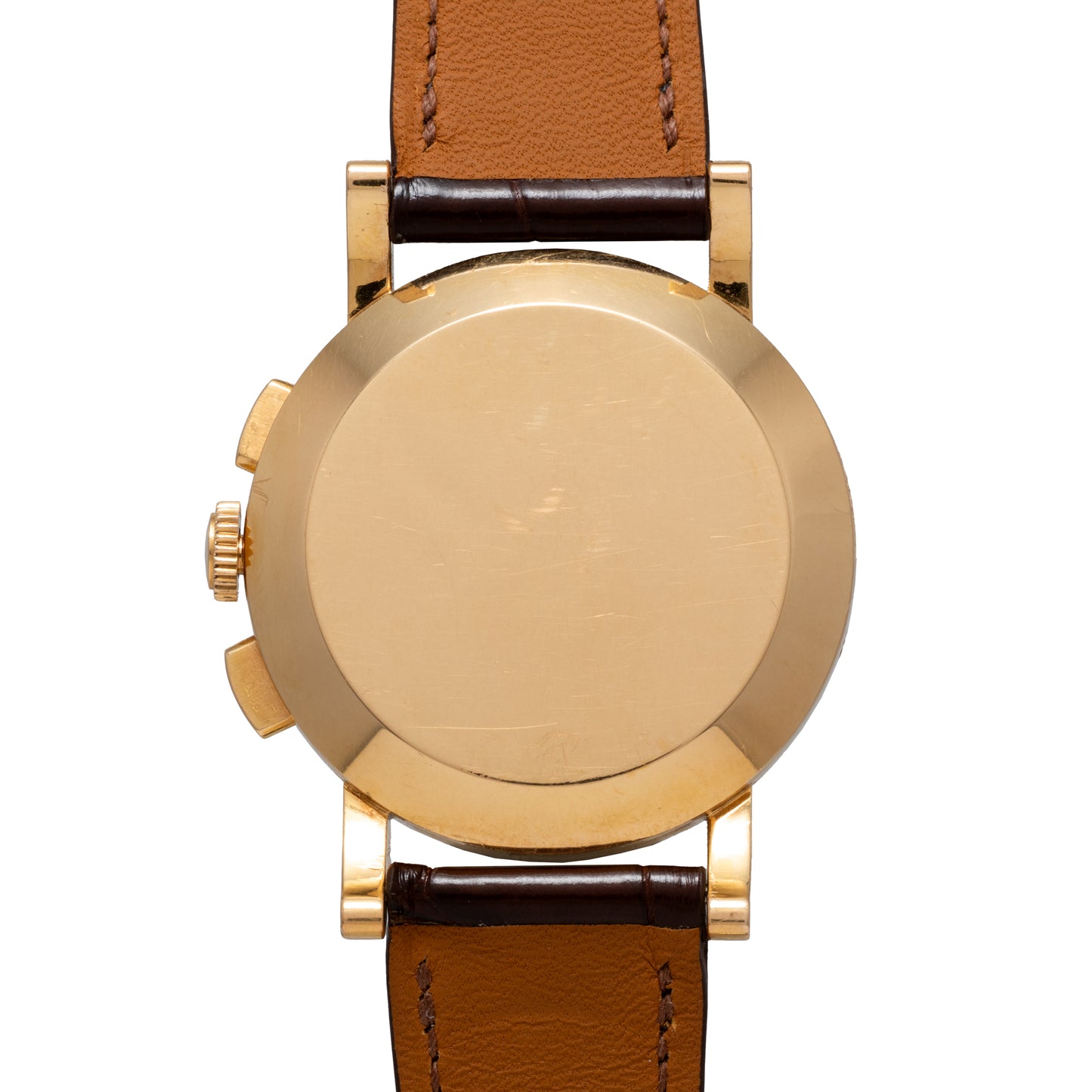 A close-up of the back of the Omega French Market Chronograph 'Calibre 321' with a brown leather strap reveals its unmarked gold case, underscoring a timeless design and housing the iconic Omega Calibre 321 chronograph movement inside.