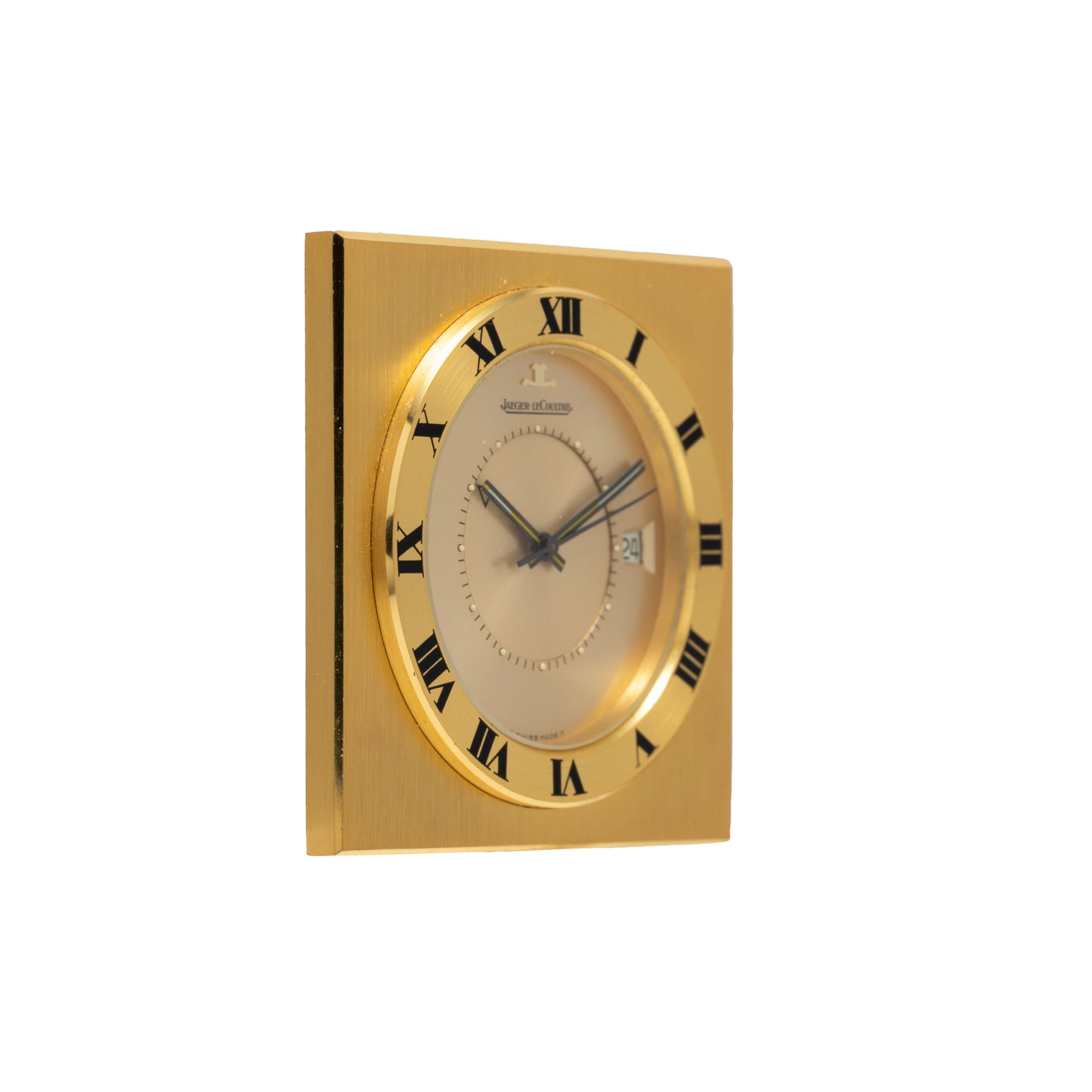 The Jaeger LeCoultre Memovox Travel Calendar Alarm Clock features a square gilt-brass case, black Roman numerals on the bezel, silver face, two black hands for the time, date display, and alarm function.
