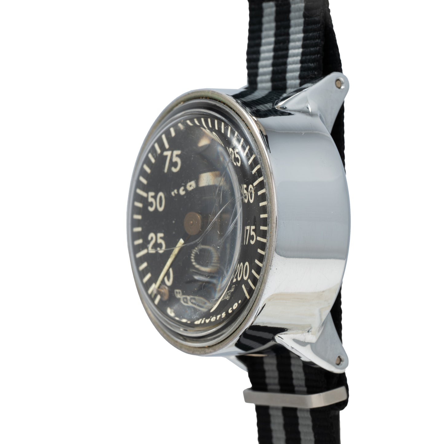 A close-up of the Calypso Depth Gauge by Calypso, featuring a black dial with white markings, metallic case, domed glass cover, and a striped black-and-white fabric strap—ideal for scuba diving enthusiasts.