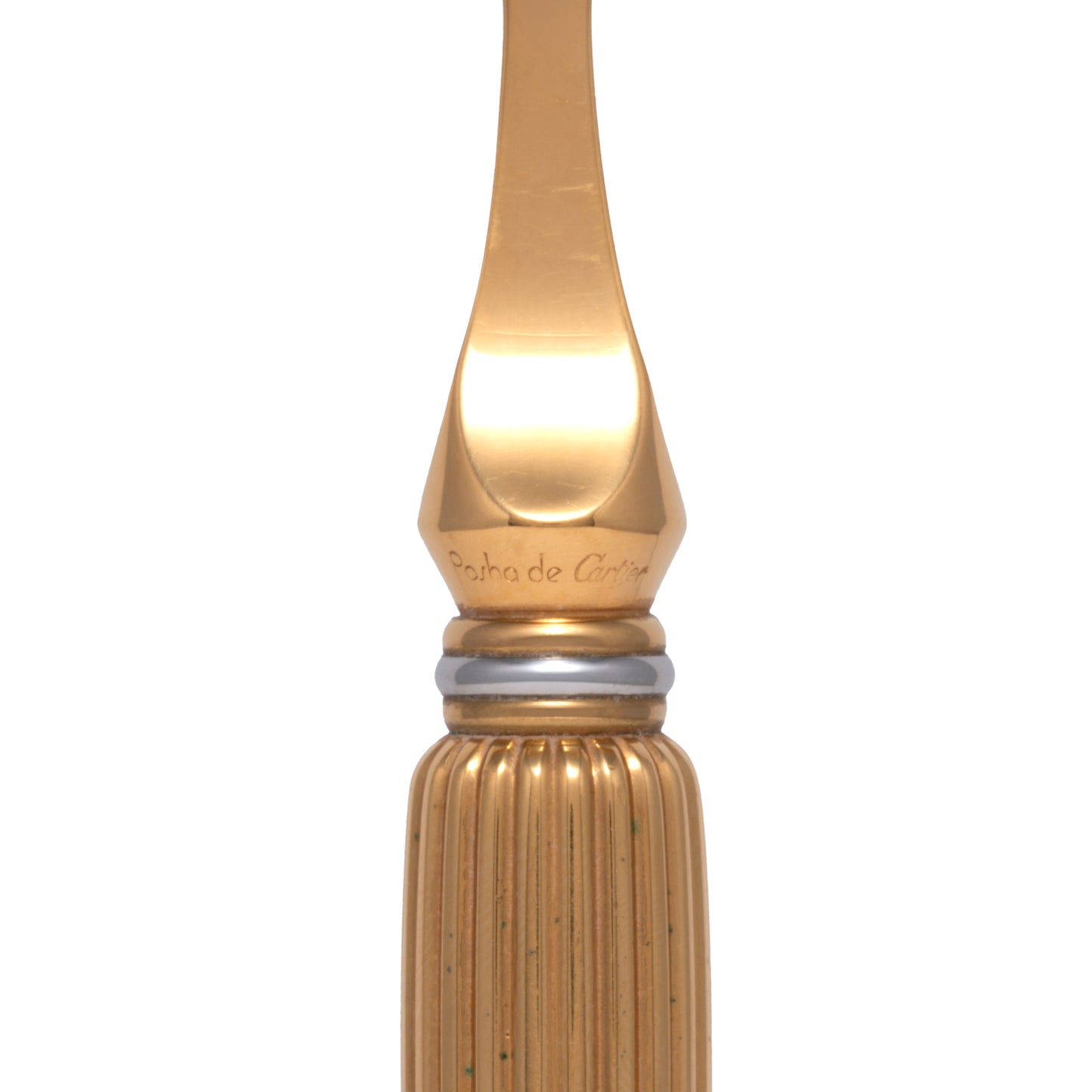 Close-up of the nib and upper barrel of a gold fountain pen with engraved text, a silver ring, and a ridged barrel—reflecting the refined details of the Cartier Pasha de Cartier Razor by Cartier, an 18K gold-plated luxury grooming tool.