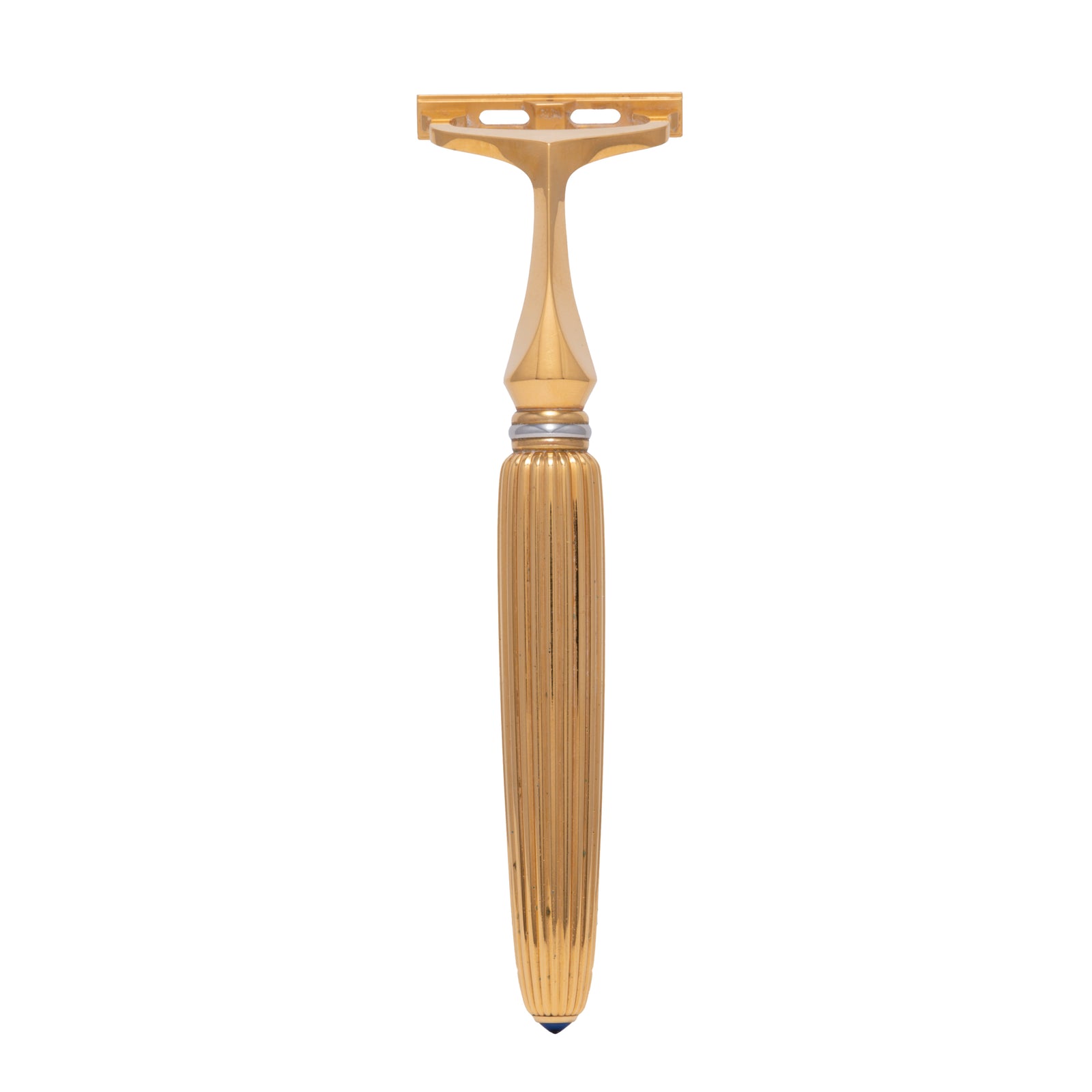 The Cartier Pasha de Cartier Razor features a gold-toned, ribbed handle and polished finish, showcasing luxury grooming on a white background.