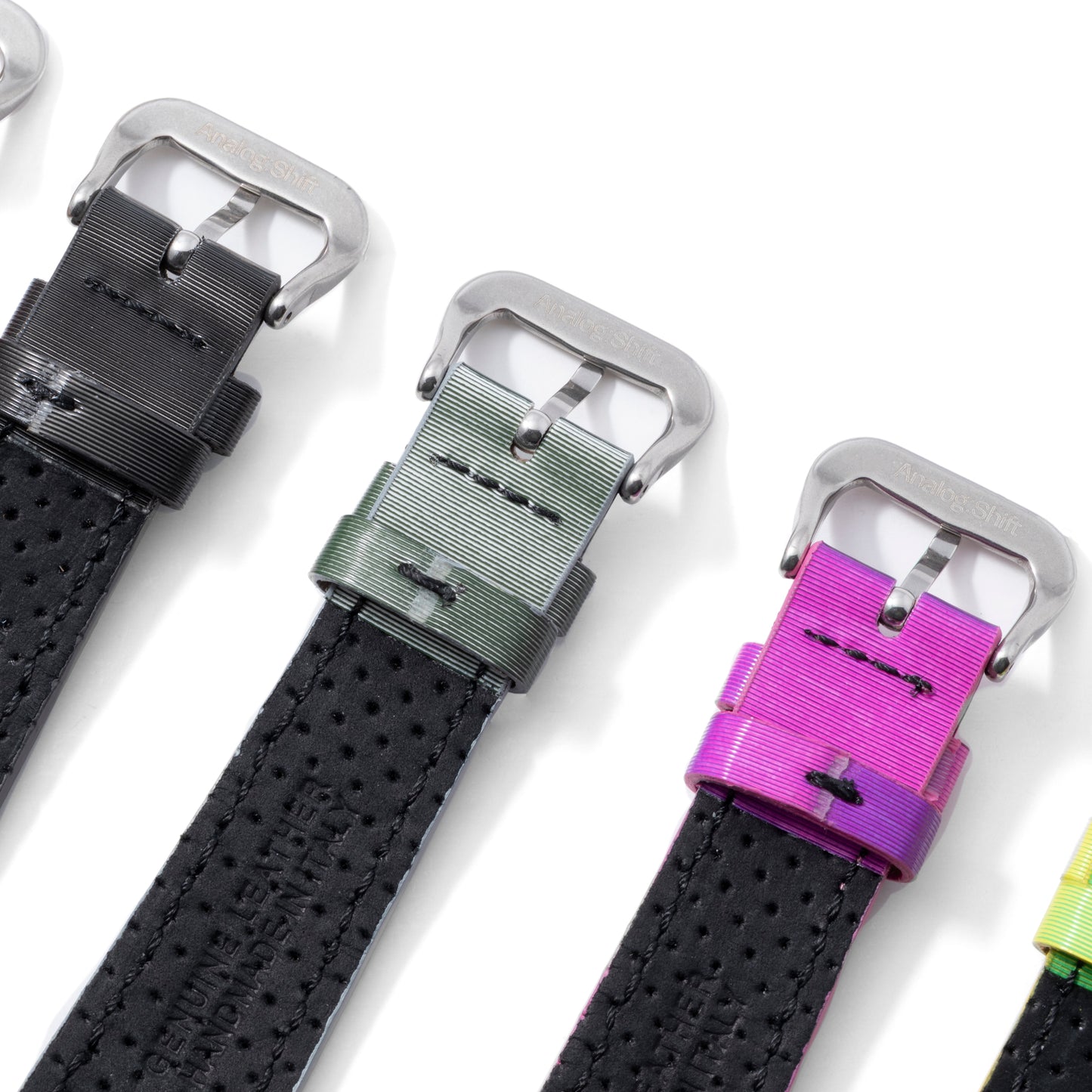 The Analog:Shift Grabber Orange Effect Matrix Straps, limited edition black perforated bands with metallic buckles and colored loops—black, green, and purple—are displayed side by side on a white background.