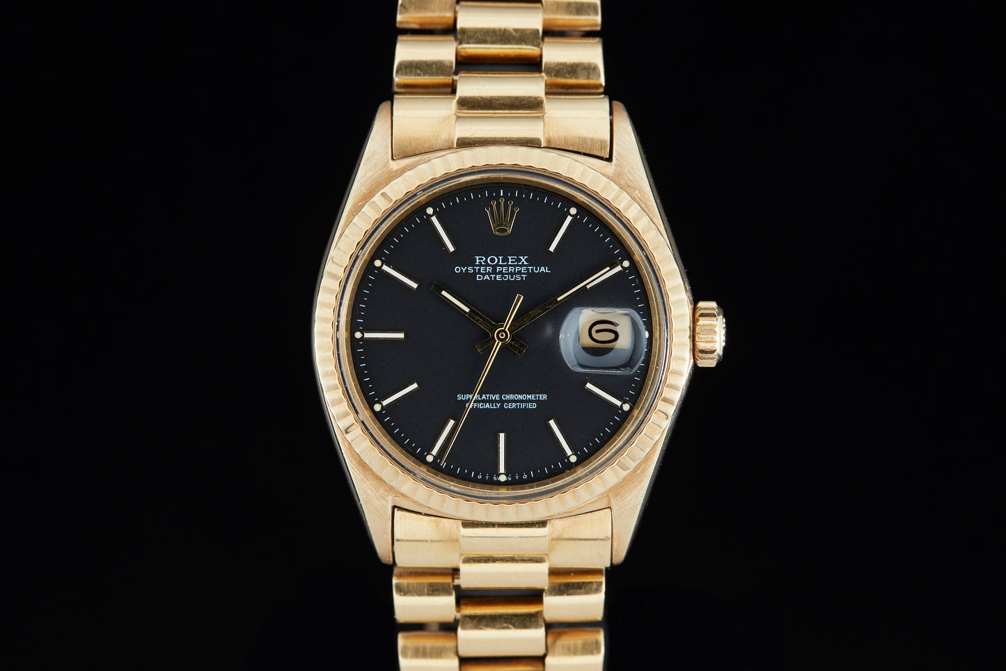 Solid gold vintage Rolex Datejust on black background