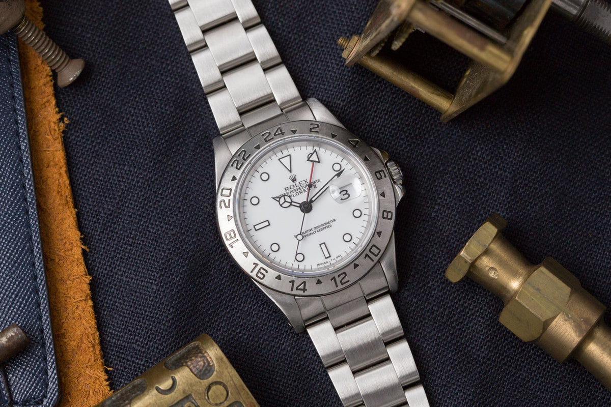 Stainless steel Rolex Explorer II watch with white dial, GMT hand, and numbered bezel on three-link bracelet, displayed on da